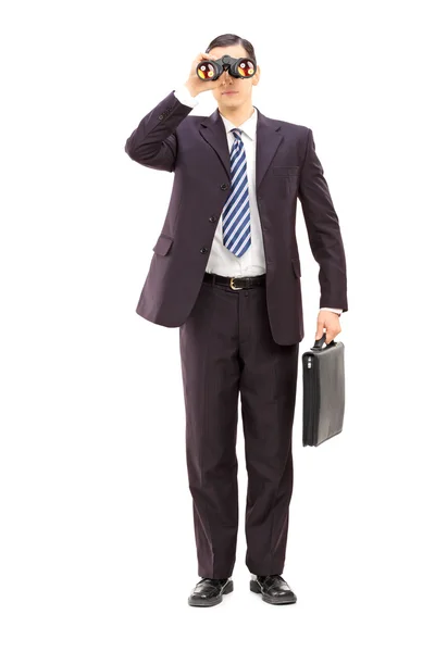 Businessman watching through binoculars — Stock Photo, Image