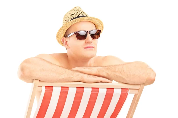 Man sitting on sun lounger — Stock Photo, Image