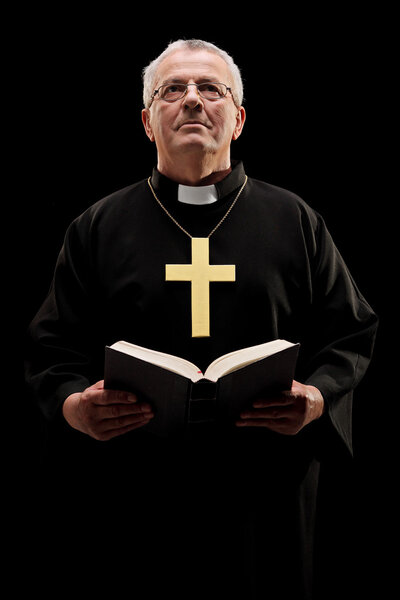 Catholic reverend holding bible