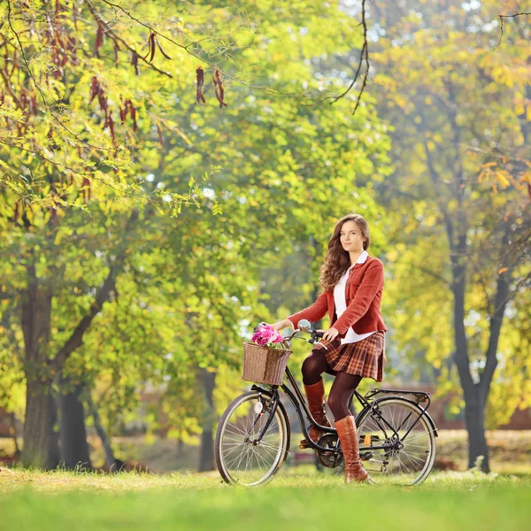 Female on bicycle in park — Stock Photo, Image