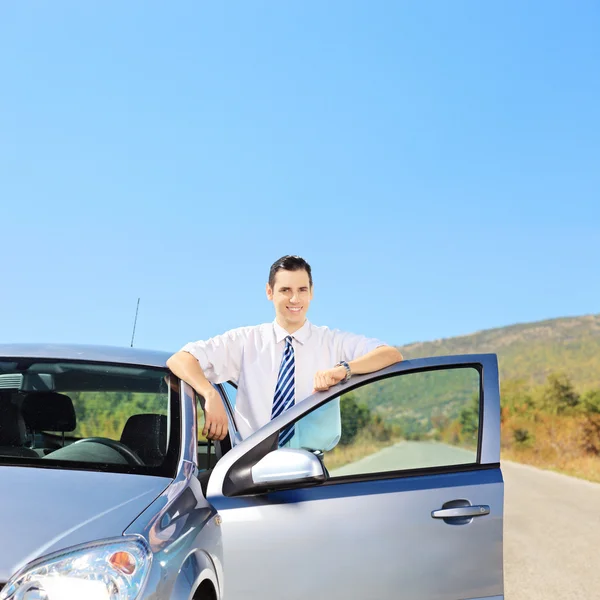 Guy next to his automobile Stock Photo