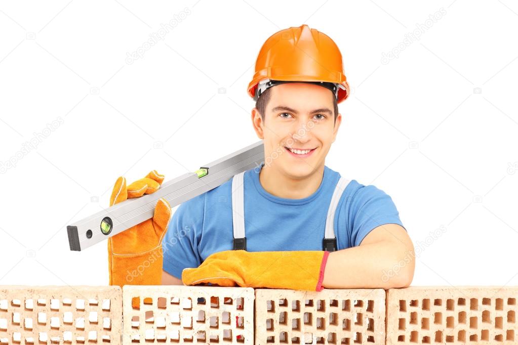 Male construction holding bubble level