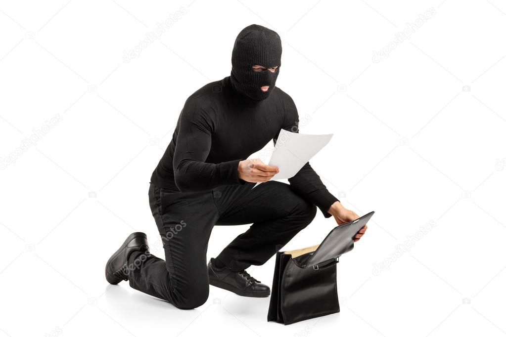 Thief reading confidential documents