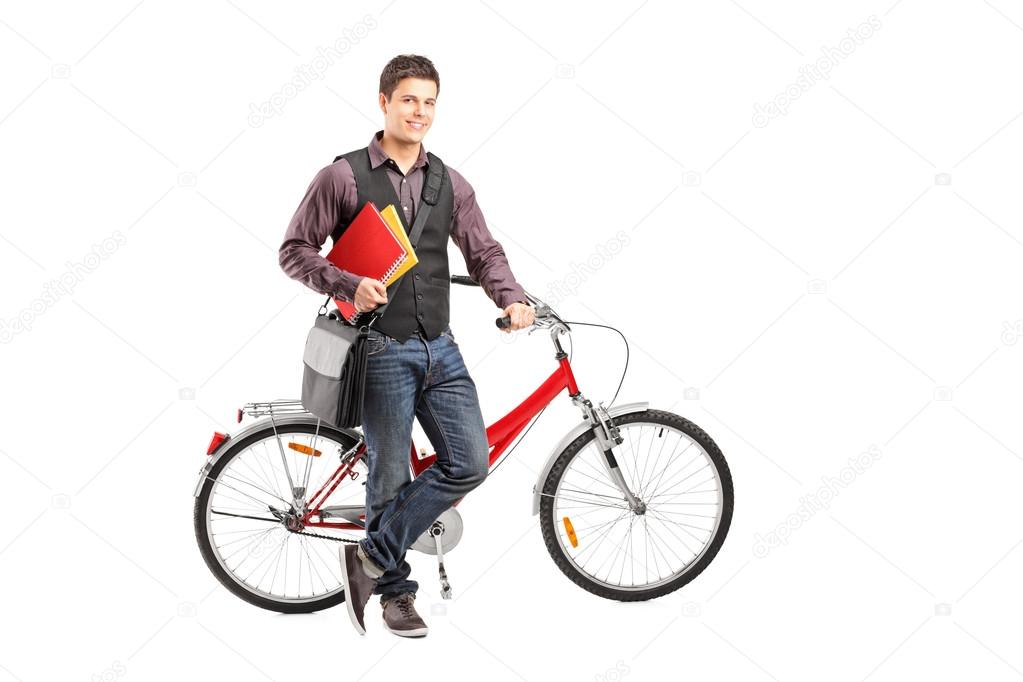 Student holding books next to bike