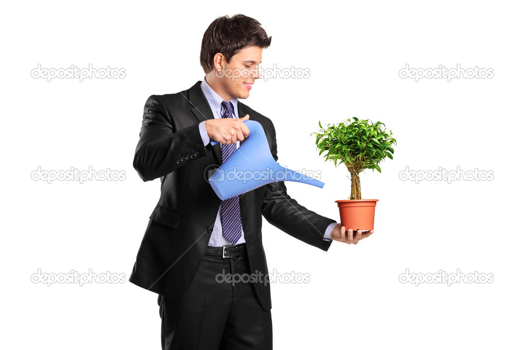 Businessman holding flower and watering can