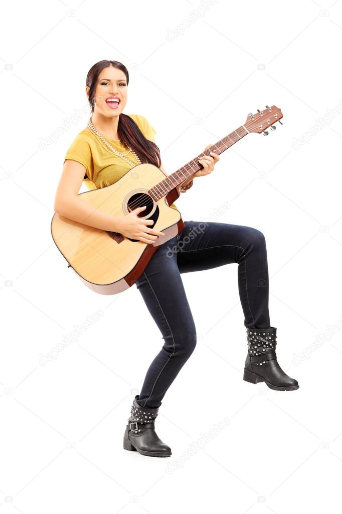 Female musician playing on guitar