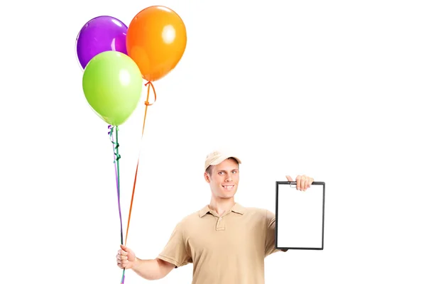 Delivery boy holding balloons — Stock Photo, Image