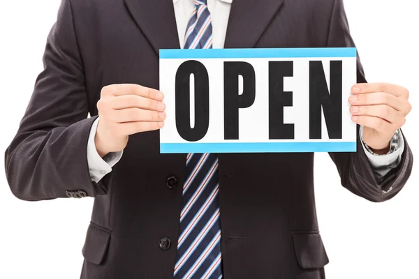 Man in black suit holding an open sign — Stock Photo, Image