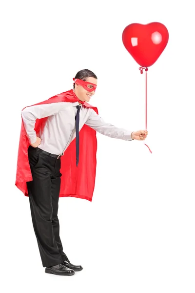 Superhero holding a red balloon — Stock Photo, Image