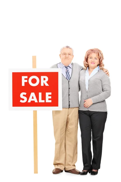 Muž a žena, která stojí ve znamení — Stock fotografie