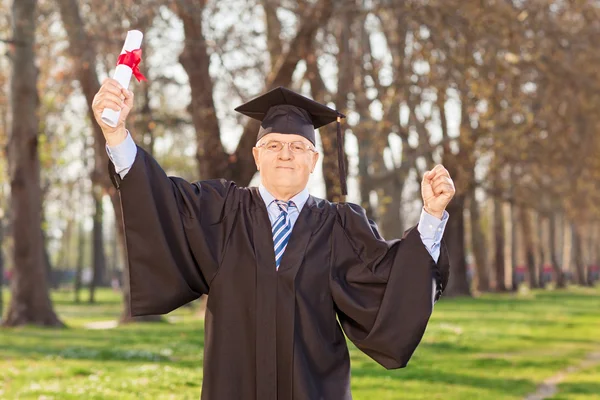Mature man holding a diploma — Stock Photo, Image