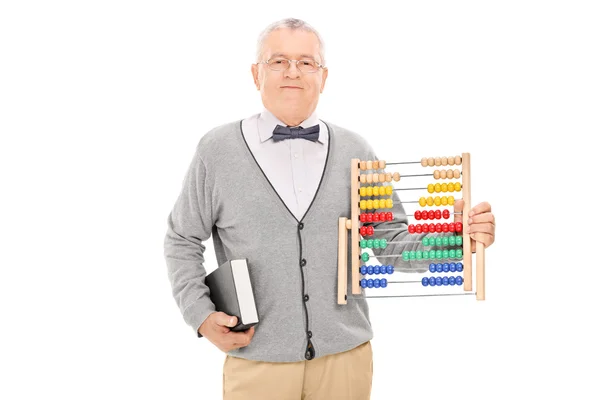 Teacher holding book and abacus — Stock Photo, Image