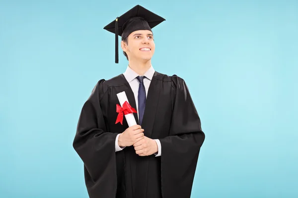 Graduate student holding a diploma — Stock Photo, Image