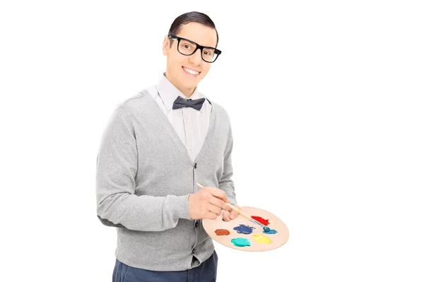 Artist holding paintbrush and pallet — Stock Photo, Image