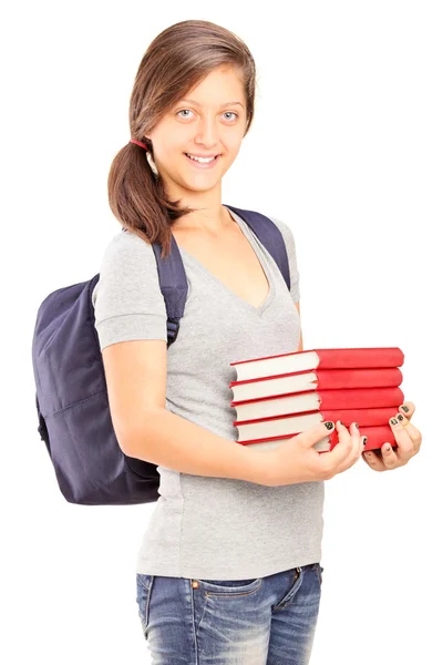 Schoolgirl holding pile of books — Stock Photo, Image