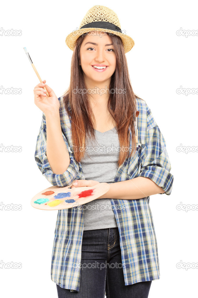Beautiful female artist holding paintbrush