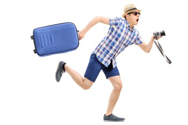 Tourist with baggage and camera clipart
