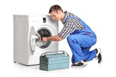 Plumber fixing washing machine