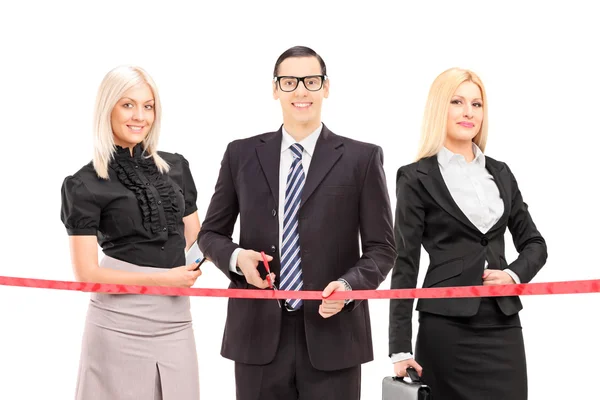 Business people cutting red tape — Stock Photo, Image