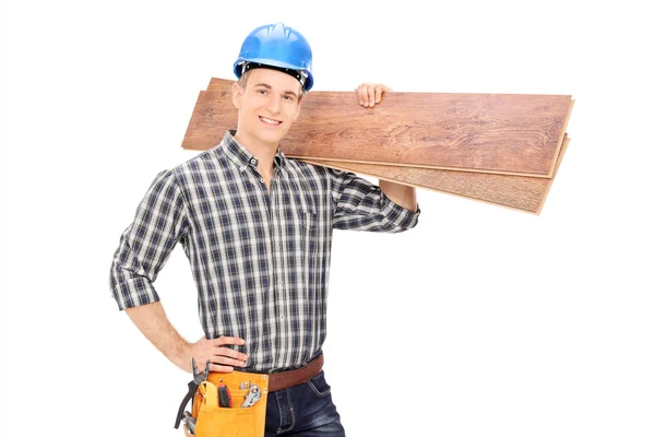 Construction worker holding planks — Stock Photo, Image