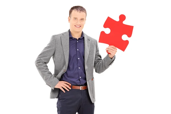 Man holding piece of puzzle — Stock Photo, Image