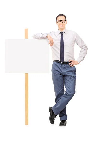 Man leaning on blank poster — Stock Photo, Image