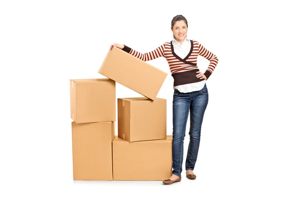 Woman next to carton boxes — Stock Photo, Image