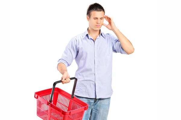 Guy holding empty shopping basket — Stock Photo, Image