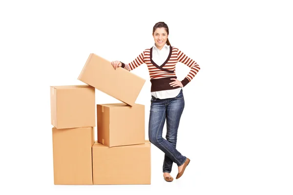 Woman standing by boxes — Stock Photo, Image