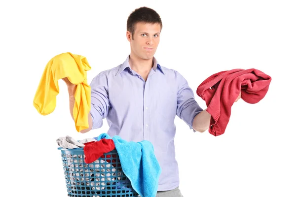 Indecisive man holding two sweaters — Stock Photo, Image