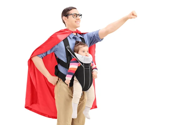 Male superhero carrying baby — Stock Photo, Image