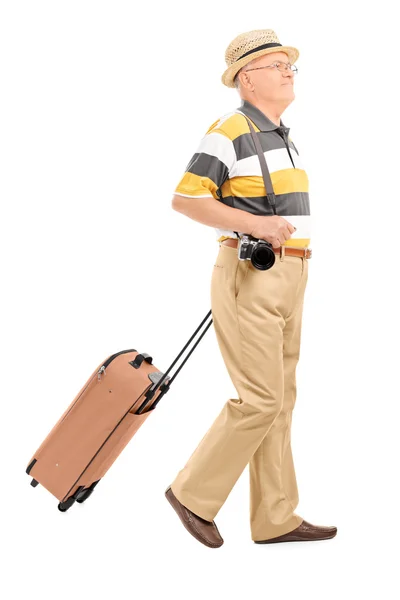 Mature tourist carrying his baggage — Stock Photo, Image