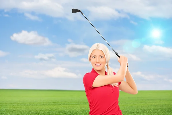 Femme jouant au golf dans le champ — Photo