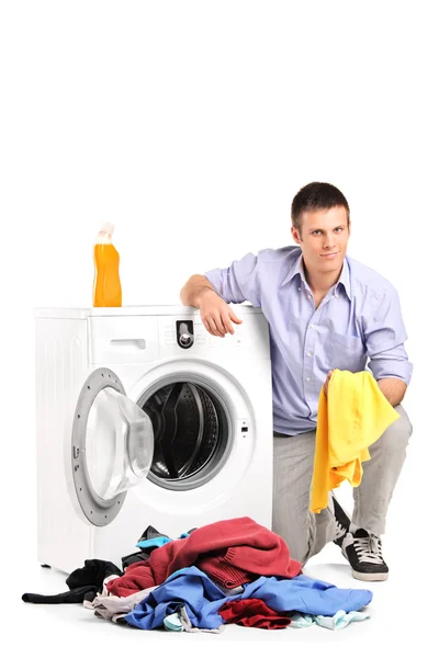 Man emptying washing machine Royalty Free Stock Images