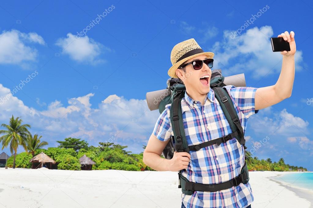 Tourist taking selfie at beach