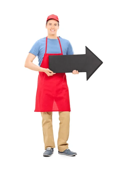 Man in apron holding arrow — Stock Photo, Image