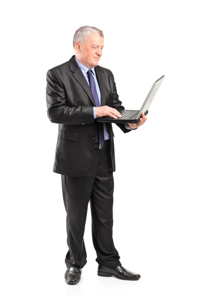 Mature businessman holding laptop — Stock Photo, Image