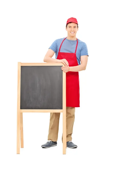 Man standing behind blackboard — Stock Photo, Image