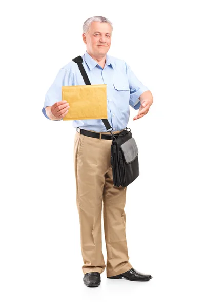 Mature mailman holding envelope — Stock Photo, Image
