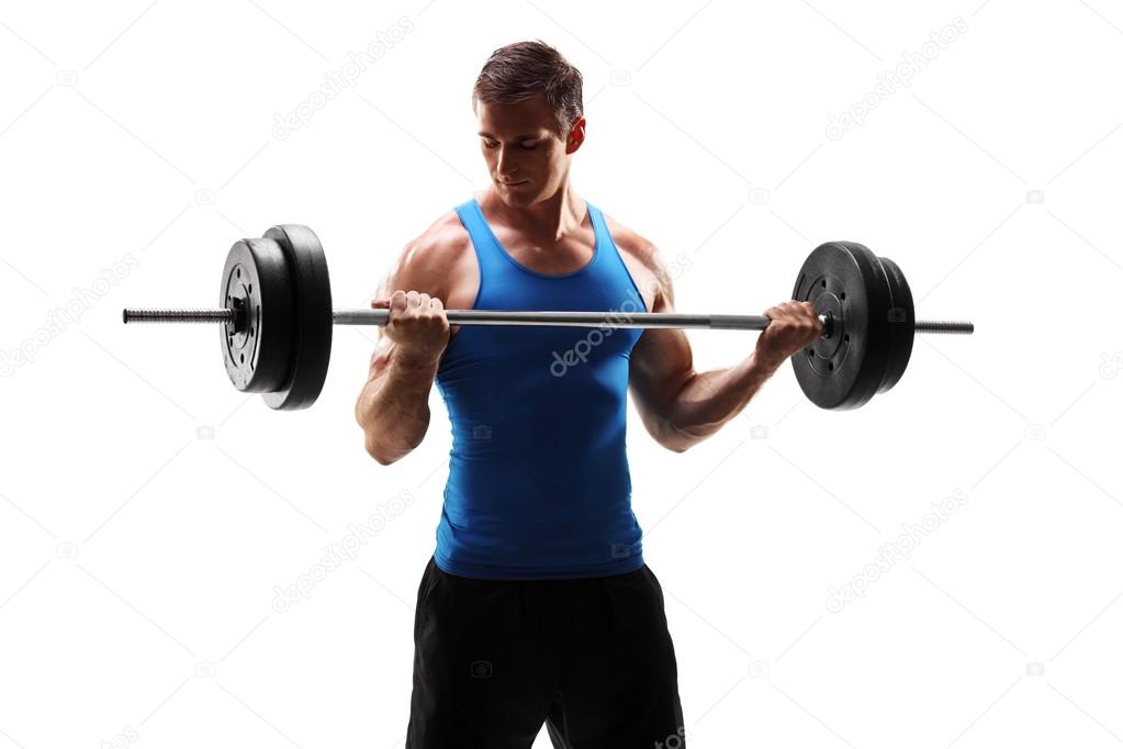 Muscular man exercising with barbell