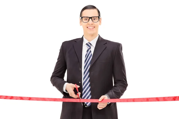 Businessman cutting red tape — Stock Photo, Image