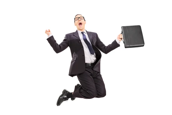 Businessman with briefcase jumping — Stock Photo, Image