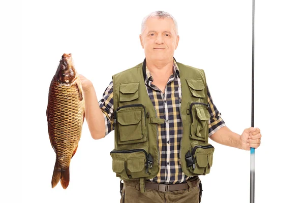 Fisherman holding fish and rod — Stock Photo, Image