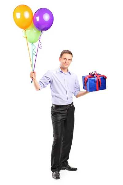 Man holding balloons and present — Stock Photo, Image