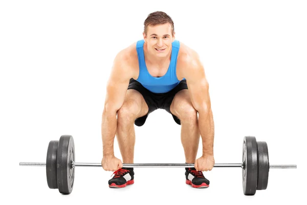 Weightlifting athlete lifting barbell — Stock Photo, Image