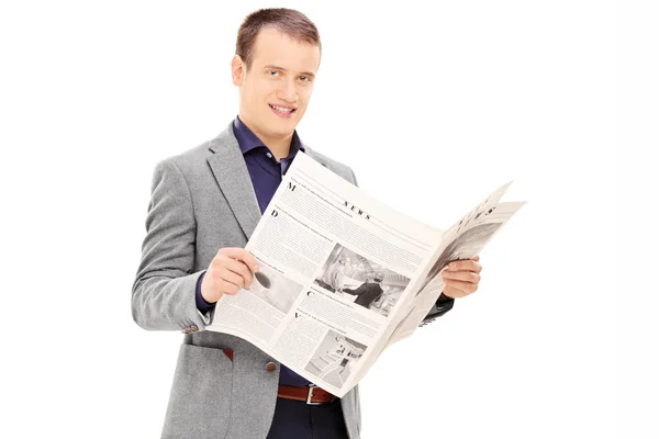 Young man holding newspaper — Stock Photo, Image