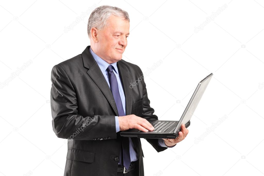 Mature businessman holding laptop