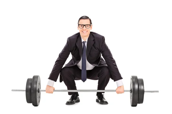 Businessman lifting heavy weight — Stock Photo, Image