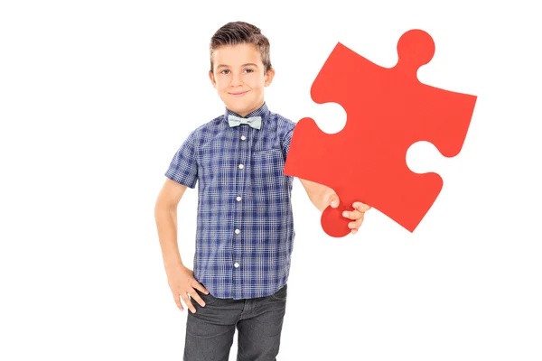 Kid holding piece of puzzle — Stock Photo, Image