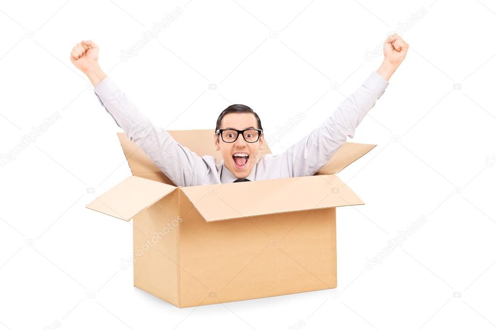 Man gesturing happiness inside box